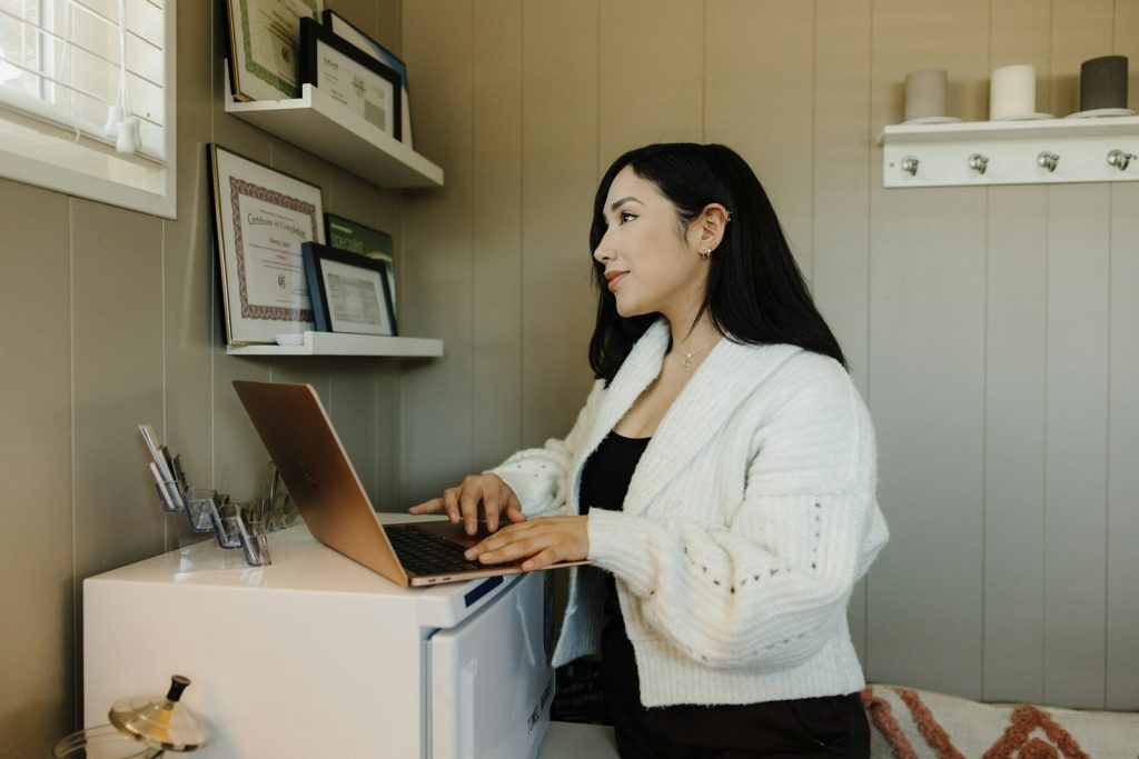 Small business owner working on a laptop at her desk